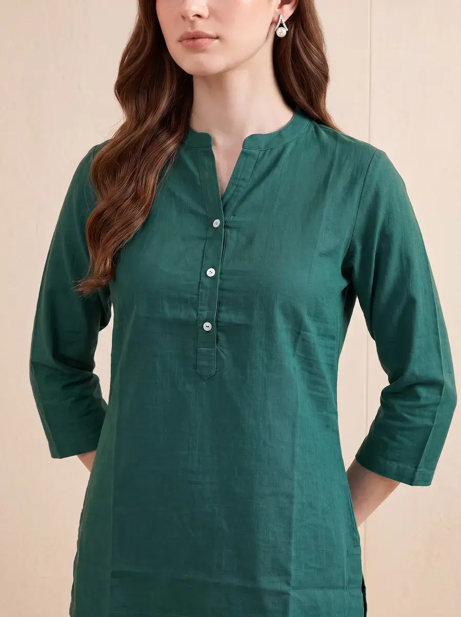 Close-up of the green kurta showing fabric texture and buttons