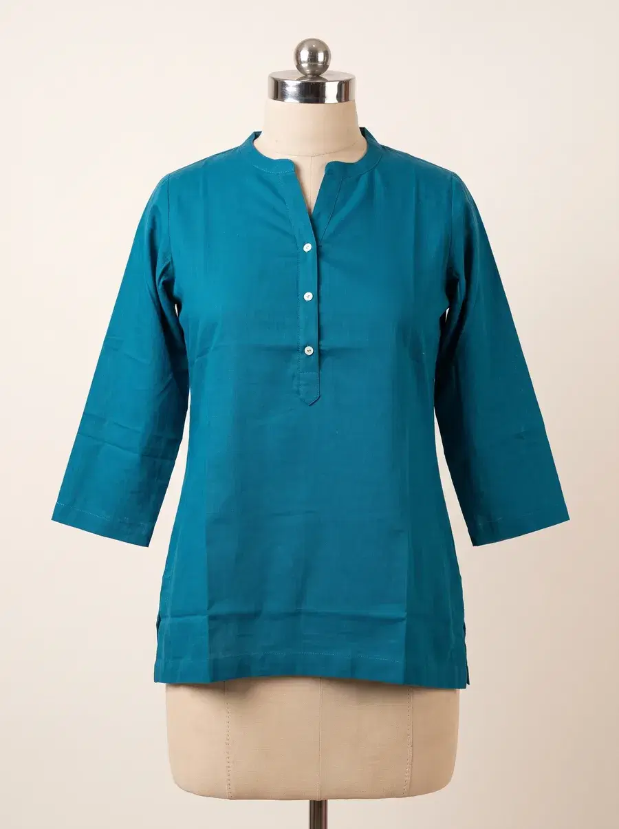 Teal cotton kurta on a dressmaker mannequin, the starting shot for ghost mannequin photography
